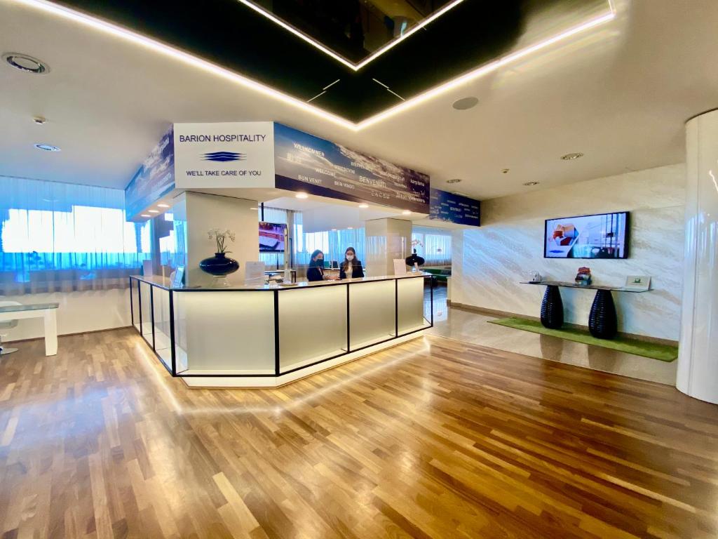 a lobby of a building with a reception counter at Barion Hotel & Congressi in Bari