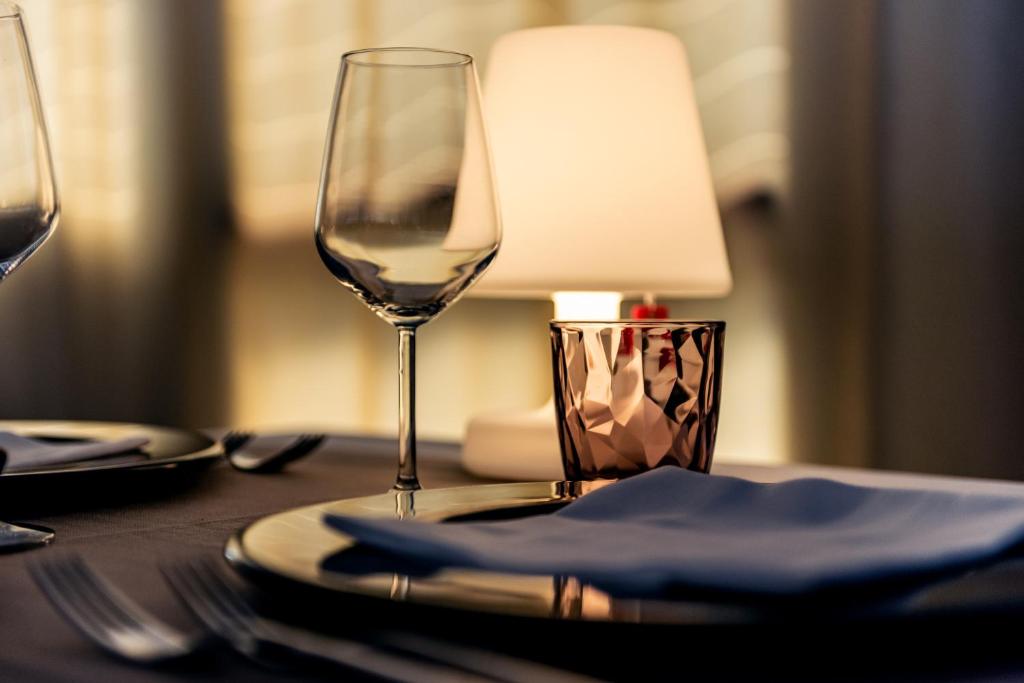 a table with a glass of wine on a table at Barion Hotel & Congressi in Bari