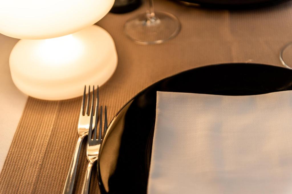 a table with a fork and a plate with a napkin at Barion Hotel & Congressi in Bari