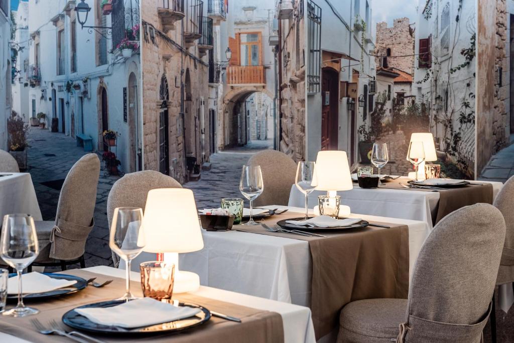a restaurant with tables and chairs on a street at Barion Hotel & Congressi in Bari