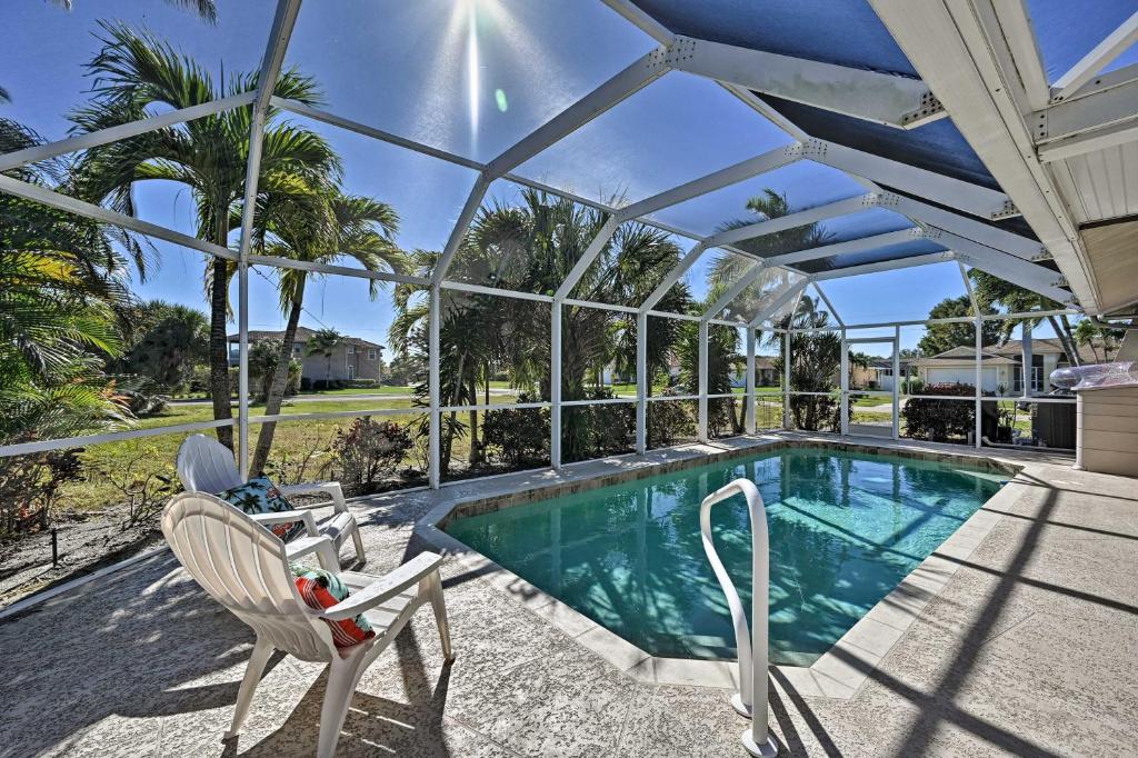 a swimming pool with a pergola next to a house at Sunny Marco Island Oasis Less Than 2 Miles to Beach! in Marco Island