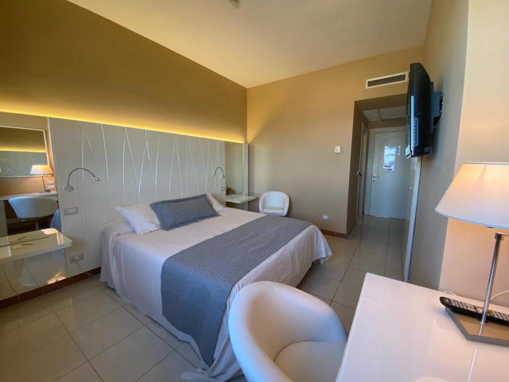 a hotel room with a bed and a television at Barion Hotel & Congressi in Bari