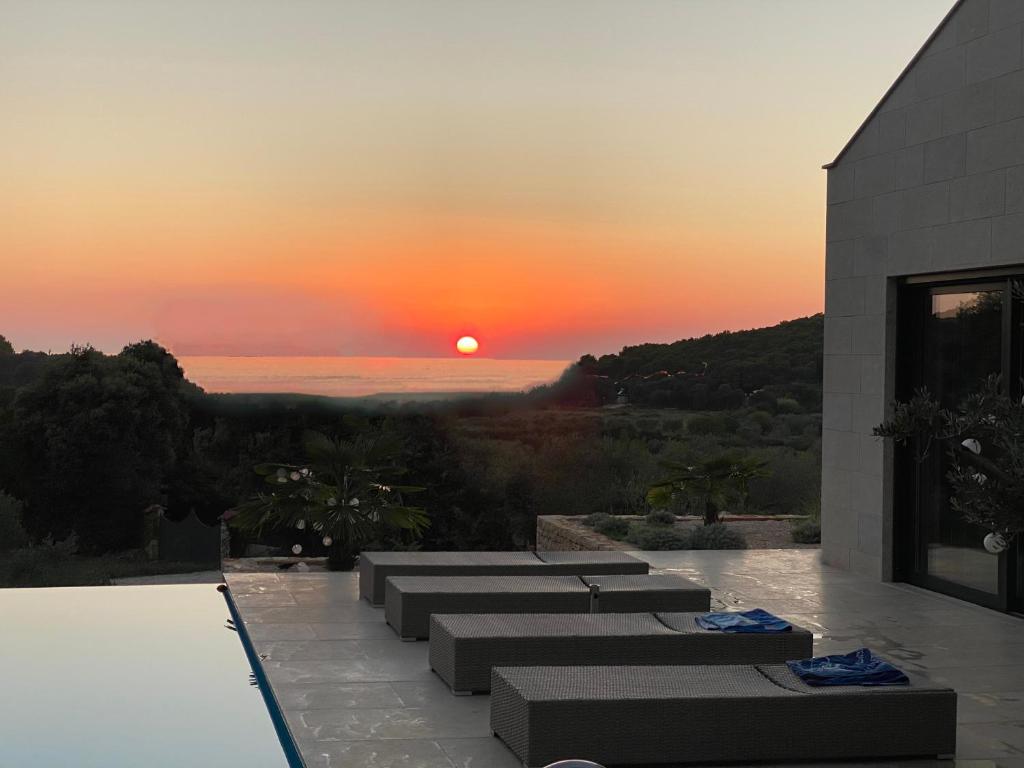 a sunset over the ocean from a house at Villa Tramonto in Rovinj