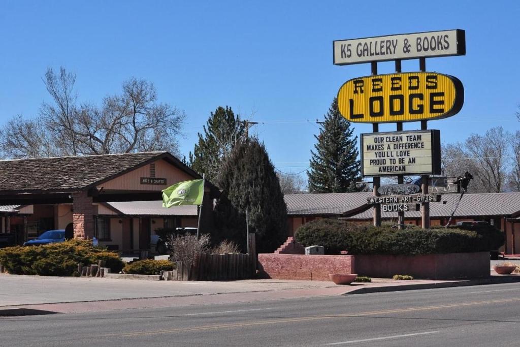 a sign for a fast food restaurant with a gas station at Reeds Lodge in Springerville