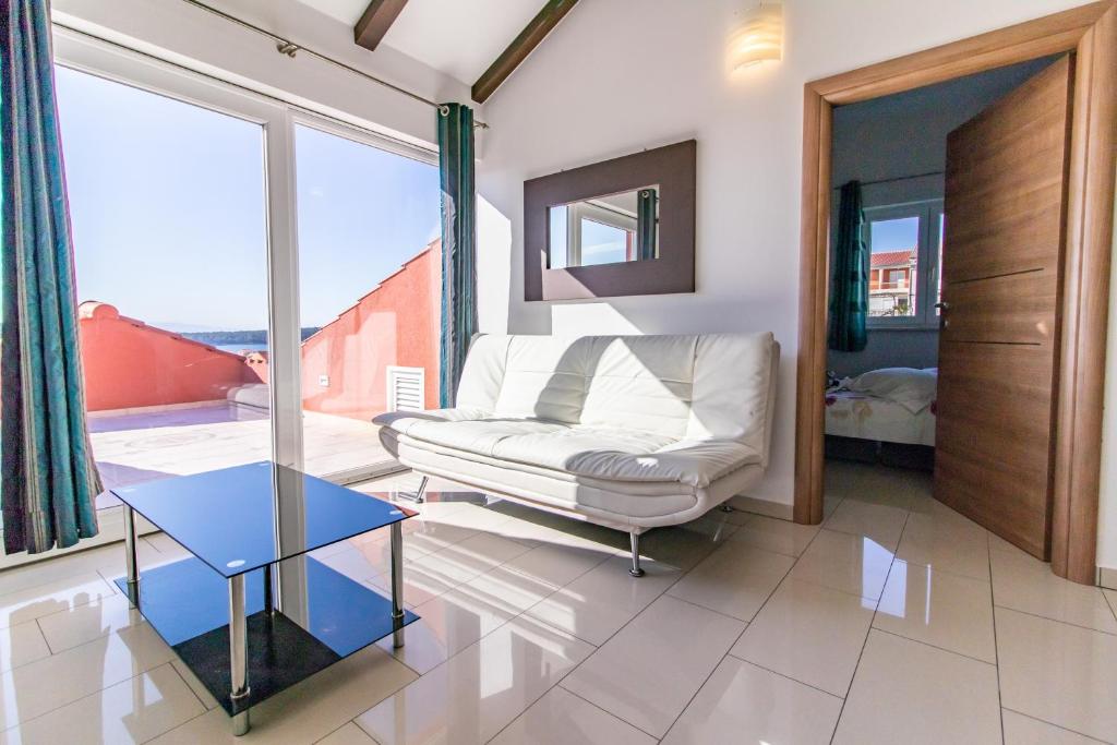 a living room with a couch and a table at Petra Apartment in Rab