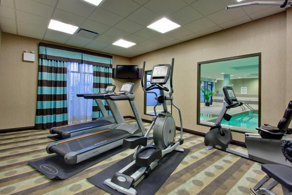 a gym with cardio equipment in a hotel room at Holiday Inn Express & Suites Ottawa West - Nepean by IHG in Ottawa