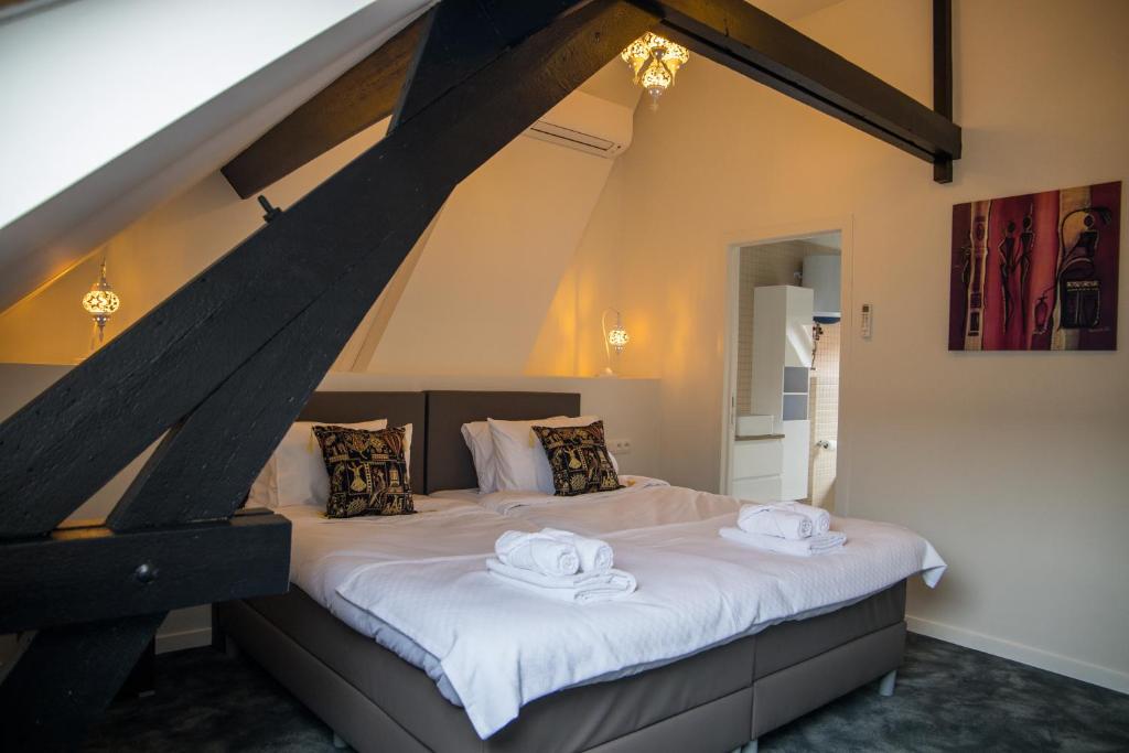 a bedroom with a bed with two towels on it at Hotel Guzy in Lier