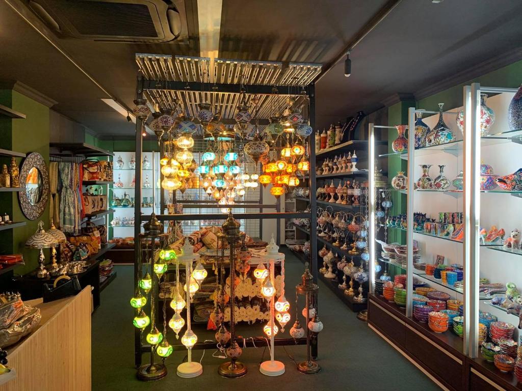 a shop with chandeliers and other items on display at Hotel Guzy in Lier