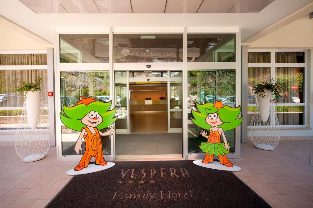 a lobby with two cartoon characters painted on the doors at Family Hotel Vespera in Mali Lošinj
