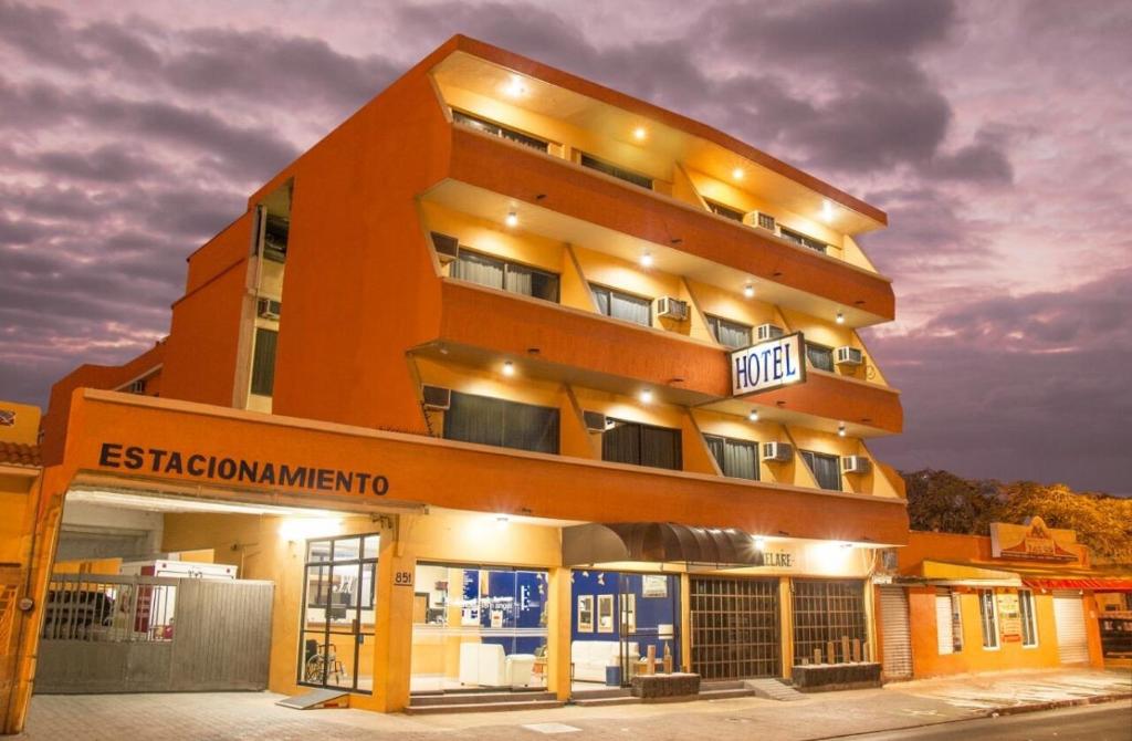 an orange building with a sign in front of it at Hotel San Angel Cerca Del Acuario in Veracruz