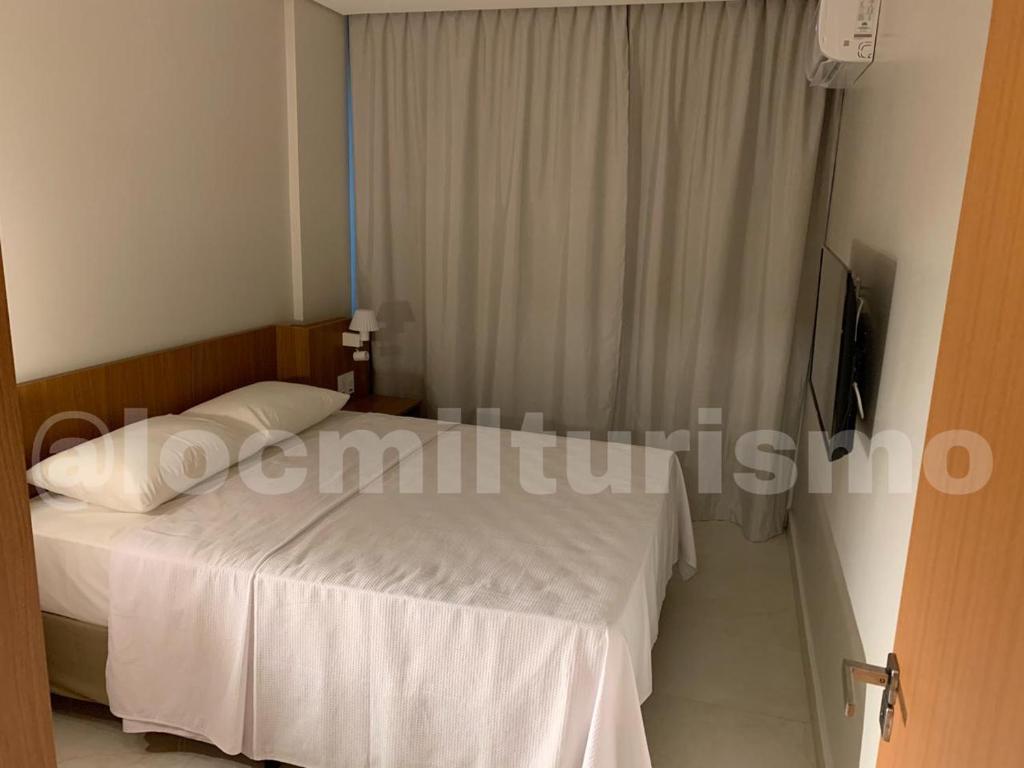 Postel nebo postele na pokoji v ubytování Apartamento em Resort - Exclusive