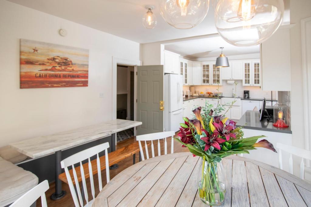 a room with a table, chairs, and a vase of flowers at Hayes Valley Inn in San Francisco