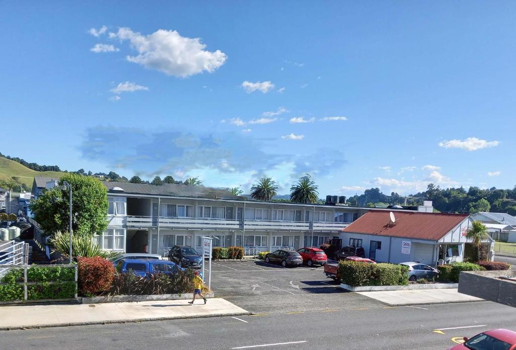 a person walking in front of a building at Alexander Motel in Taumarunui