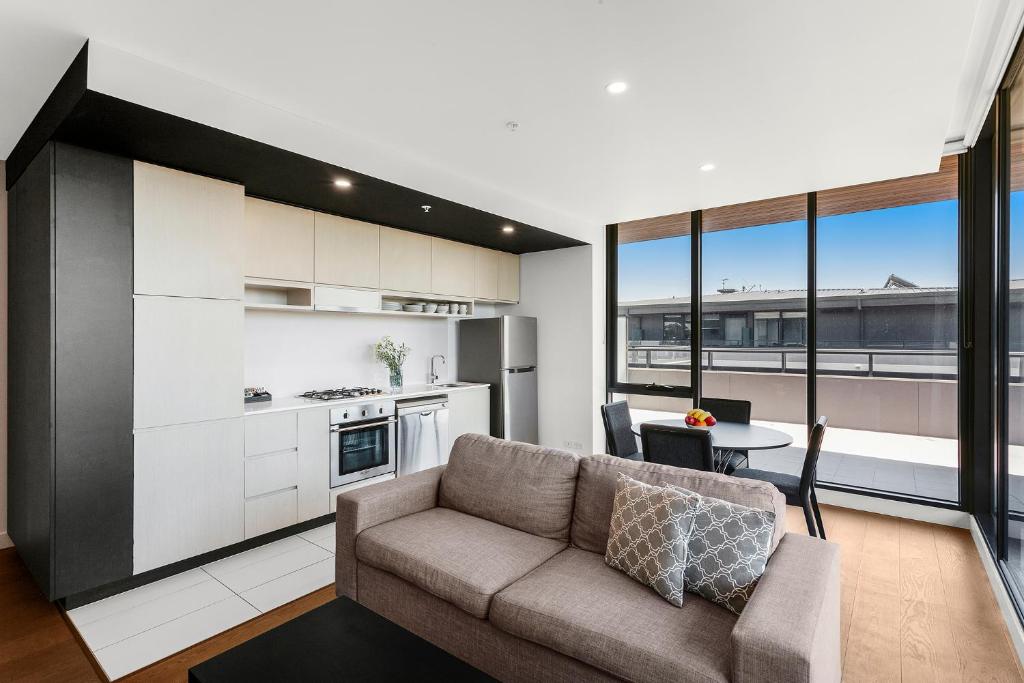 a living room with a couch and a table at Clayton Serviced Apartments in Clayton North