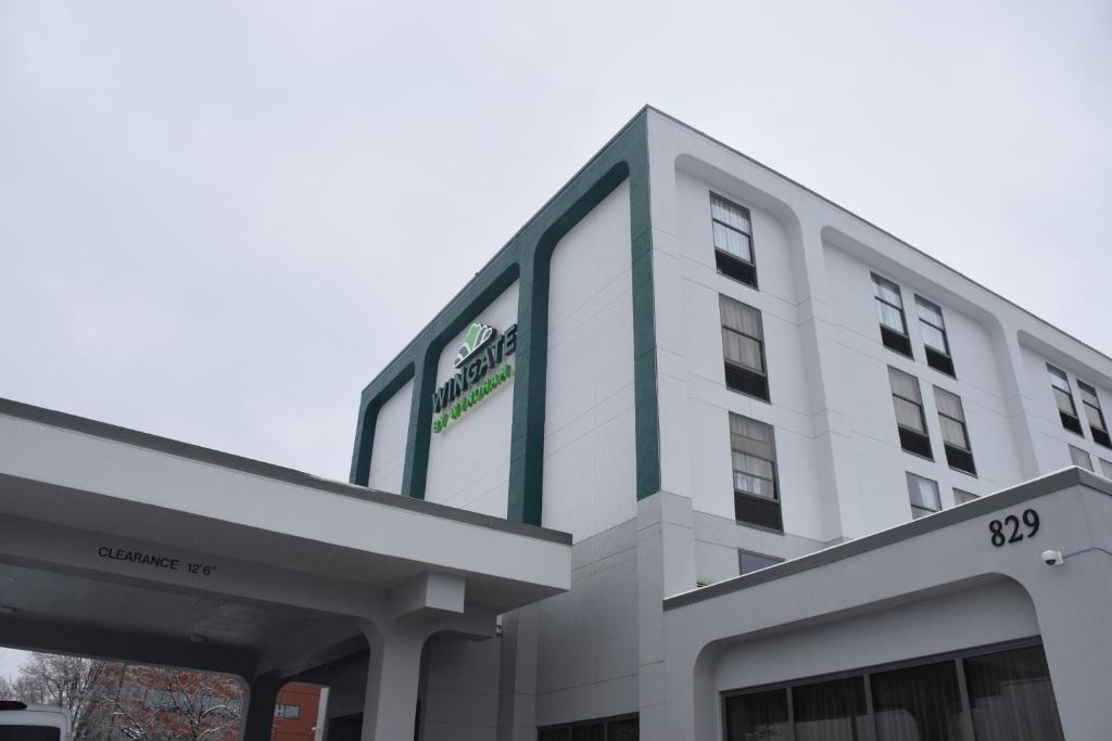 a white building with a green stripe on it at Wingate by Wyndham Baltimore BWI Airport in Baltimore