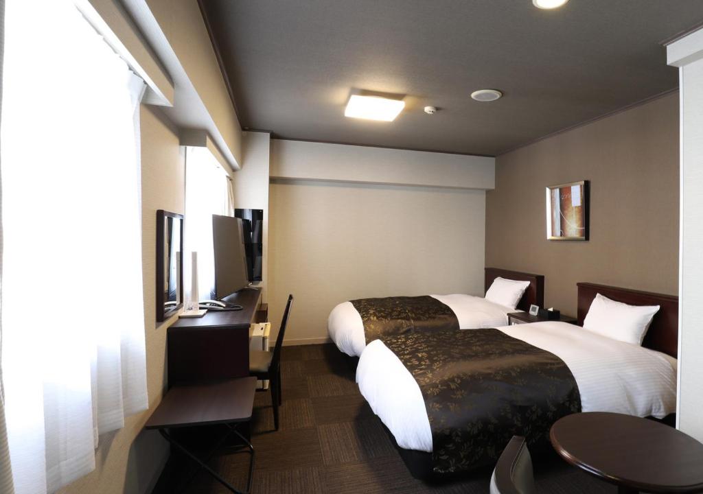Postel nebo postele na pokoji v ubytování APA Hotel Chibachuo Ekimae