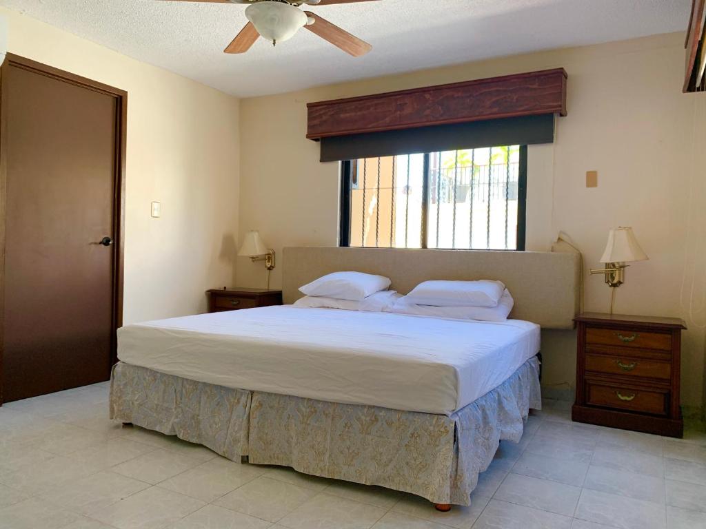 a bedroom with a large bed and a window at Casa Oyamel, Private Room in the heart of cancun in Cancún