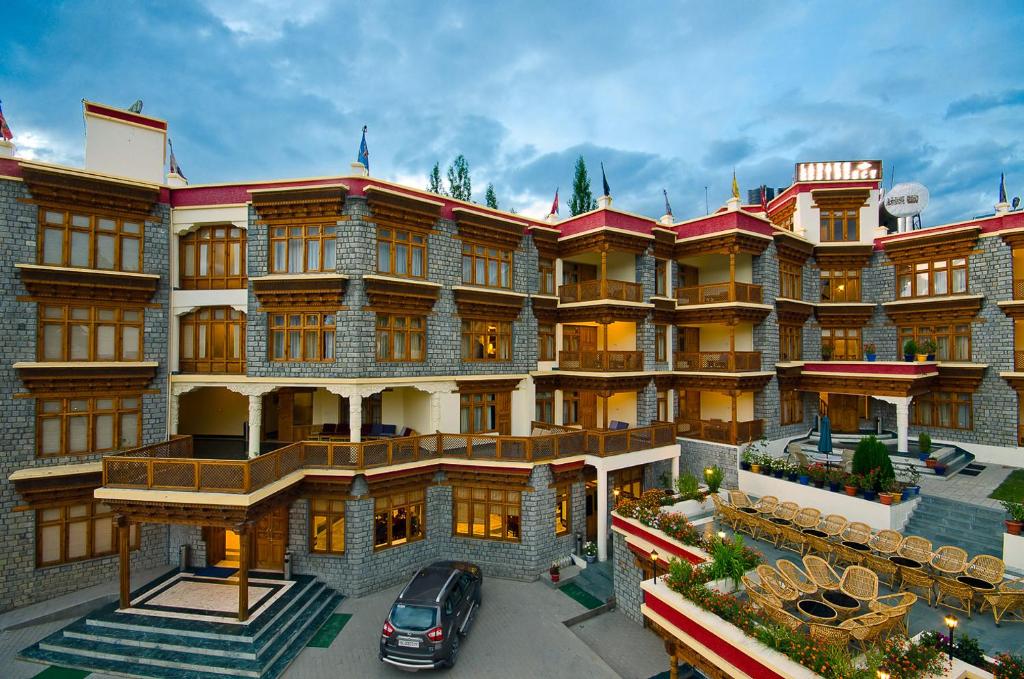 a building with a car parked in front of it at Ladakh Residency in Leh