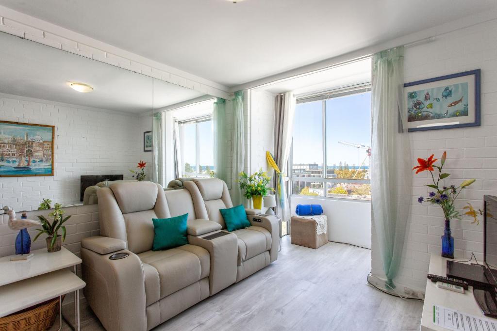 a living room with two chairs and a large window at Indian Ocean Views in Fremantle