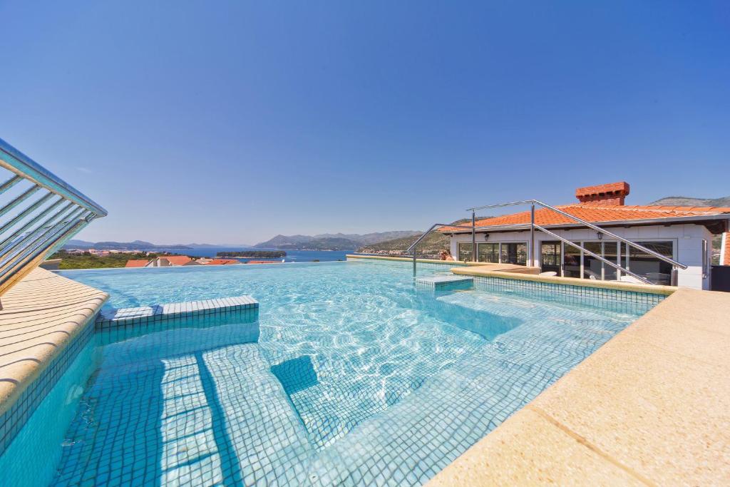 a swimming pool with a view of the water at Villa Antea Apartments in Dubrovnik