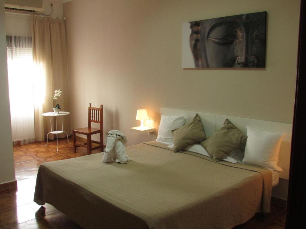 A bed or beds in a room at El Manantial