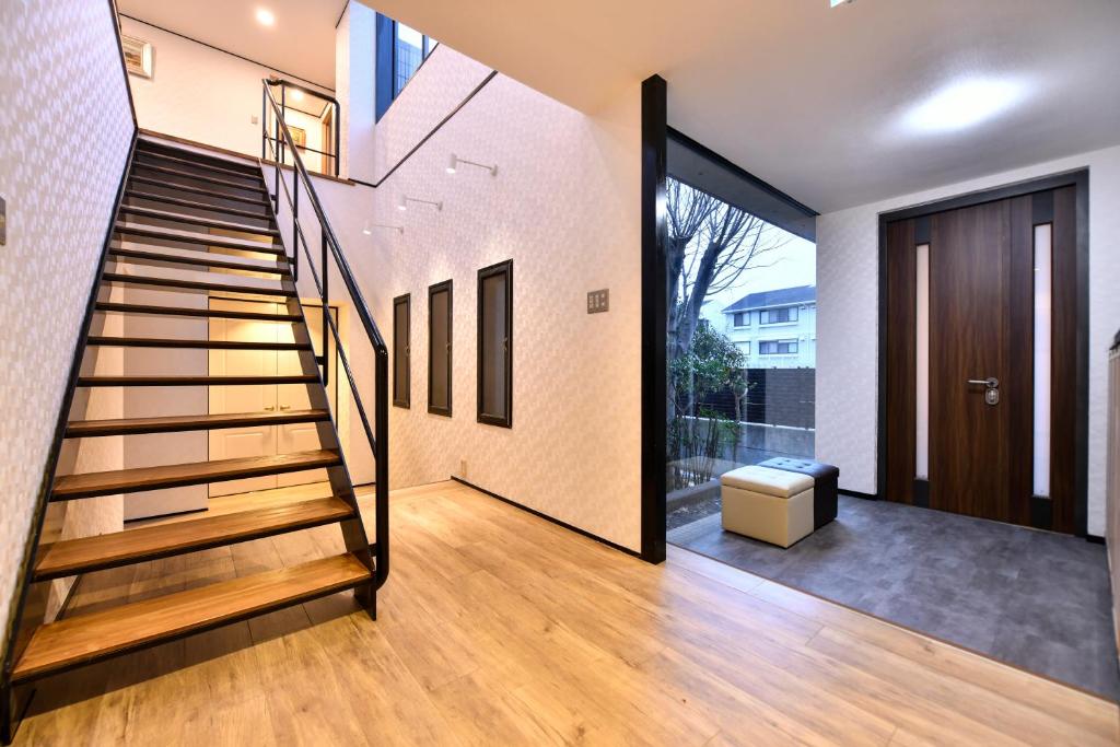a staircase in a house with a glass door at BRUCE Luxury House in Izumi-Sano