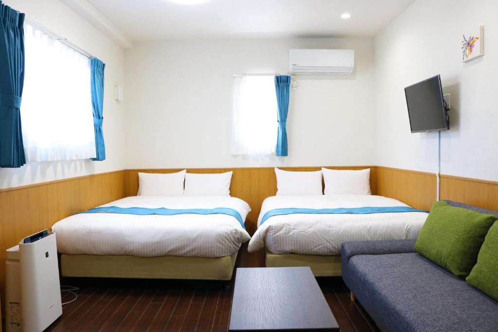 Postel nebo postele na pokoji v ubytování Phoenix Ryukyu Henzanbaru -SEVEN Hotels and Resorts-