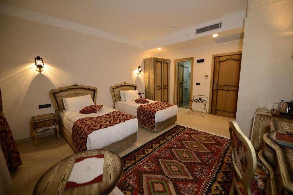 A bed or beds in a room at RAYMAR HOTELS MARDİN