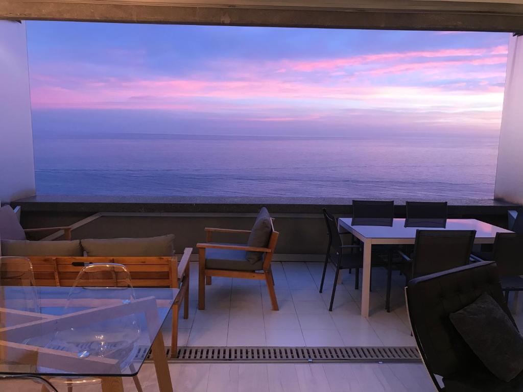 a balcony with tables and chairs and a view of the ocean at COSTA PLANA COLLECTION - Cap d'Ail - Monaco in Cap d'Ail
