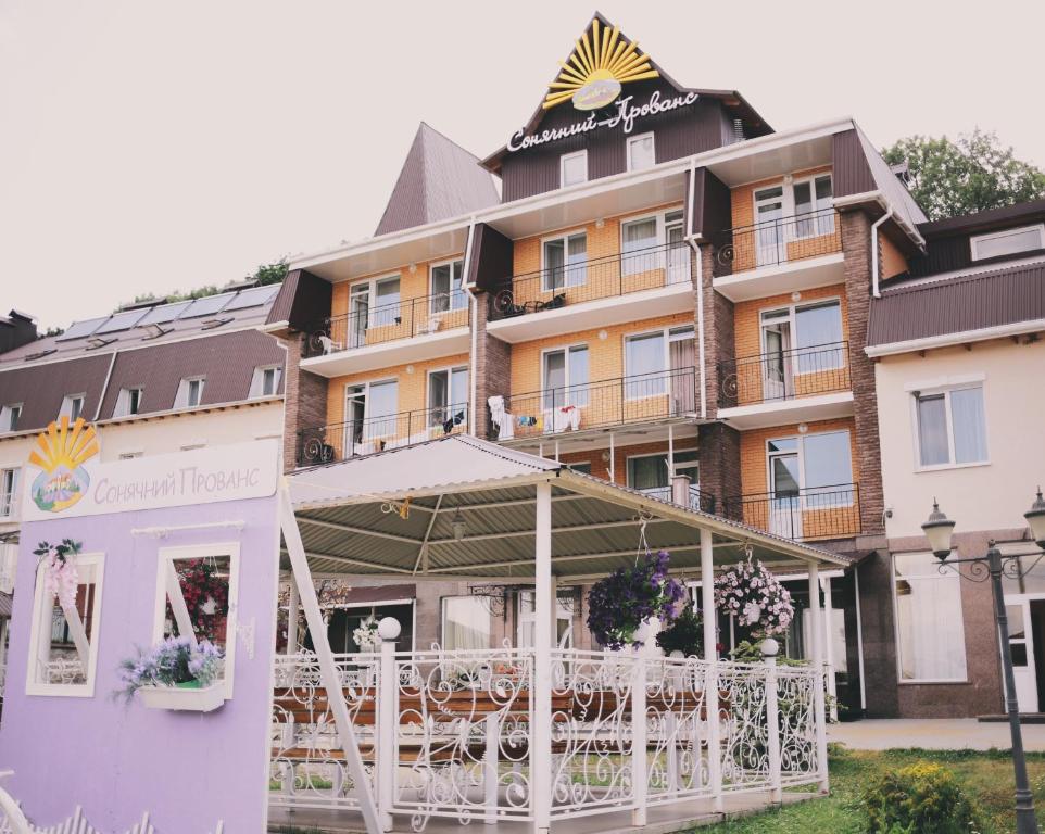 a hotel with tables and chairs in front of it at VitaPark Solnechniy Provans in Satanov