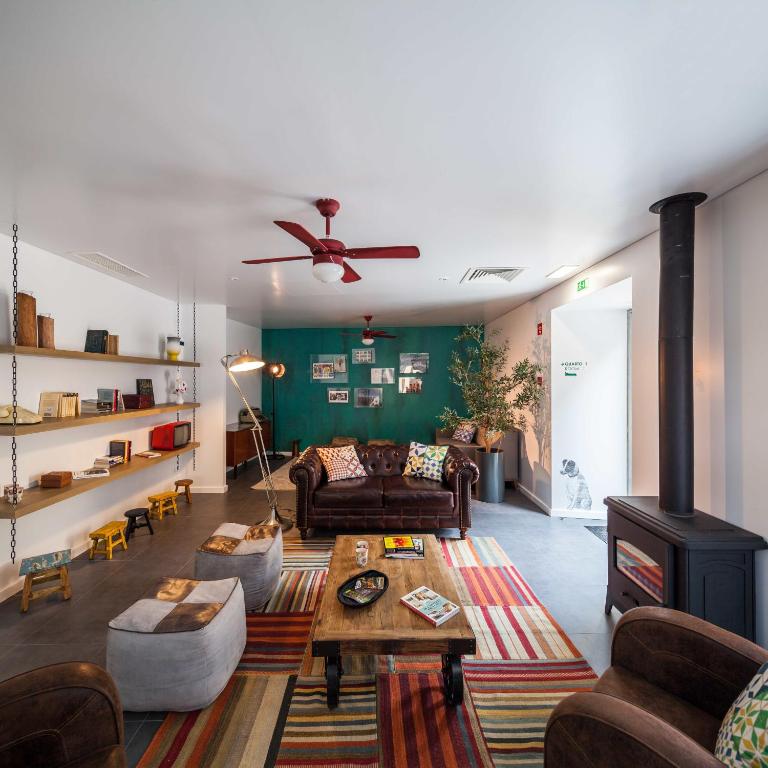 a living room with a couch and a fireplace at Moon Hill Sintra in Sintra