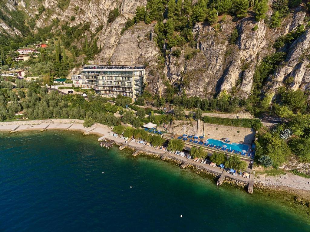 an aerial view of a resort on a beach next to the water at HOTEL ASTOR in Limone sul Garda