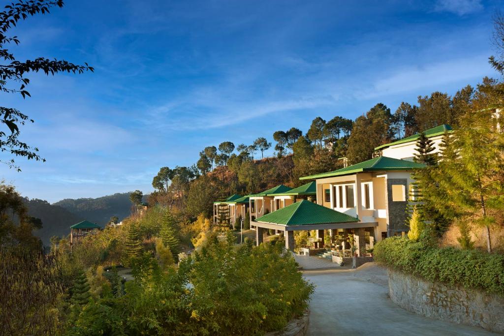 a view of a resort with a mountain at Suryavilas Luxury Resort & Spa in Kasauli