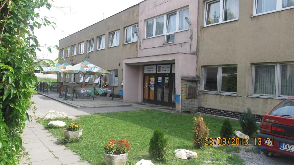 an apartment building with a yard in front of it at Sporthostel Scandinavia in Prague