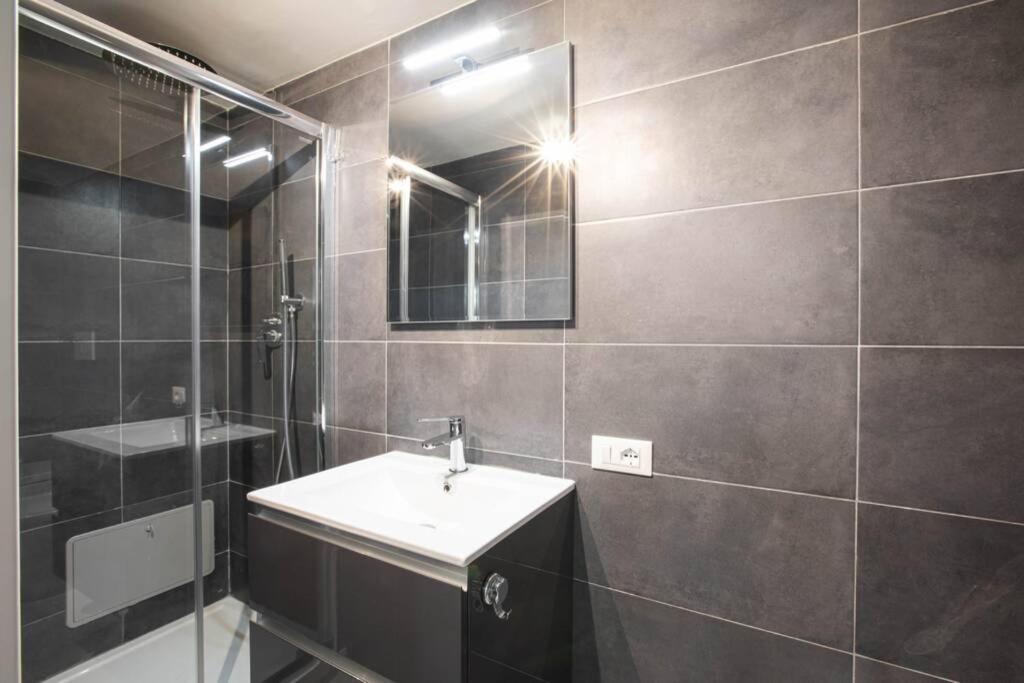 a bathroom with a sink and a mirror at Unforgettable Split Level Jacuzzi Suite Navona - Top Collection in Rome