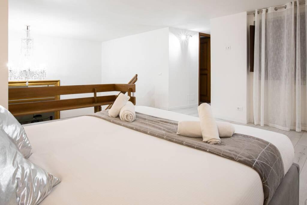 a white bed with two pillows on top of it at Unforgettable Split Level Jacuzzi Suite Navona - Top Collection in Rome