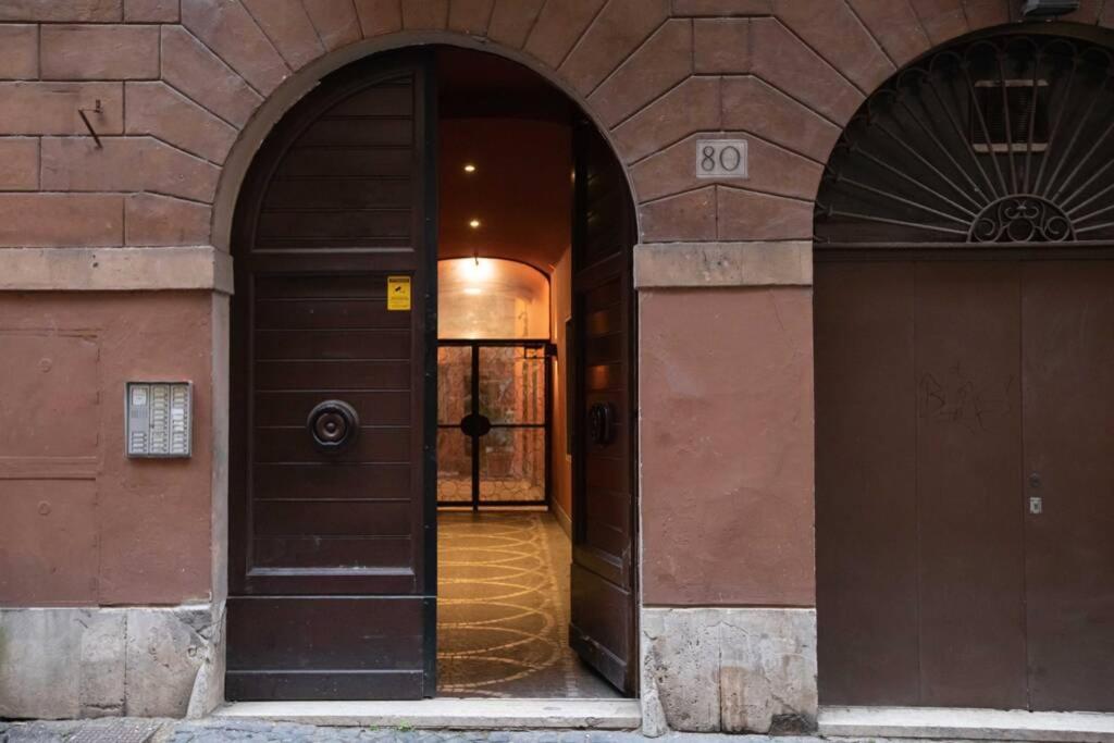 an entrance to a building with a brown door at Unforgettable Split Level Jacuzzi Suite Navona - Top Collection in Rome