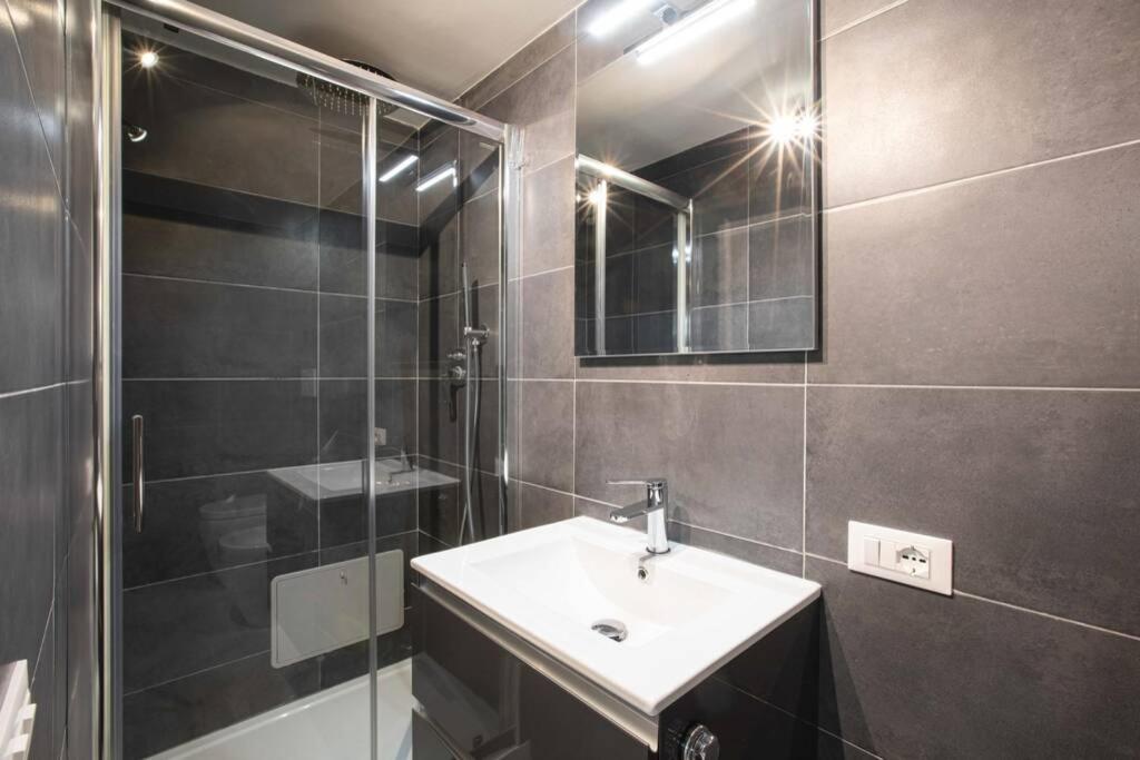 a bathroom with a sink and a shower and a mirror at Unforgettable Split Level Jacuzzi Suite Navona - Top Collection in Rome