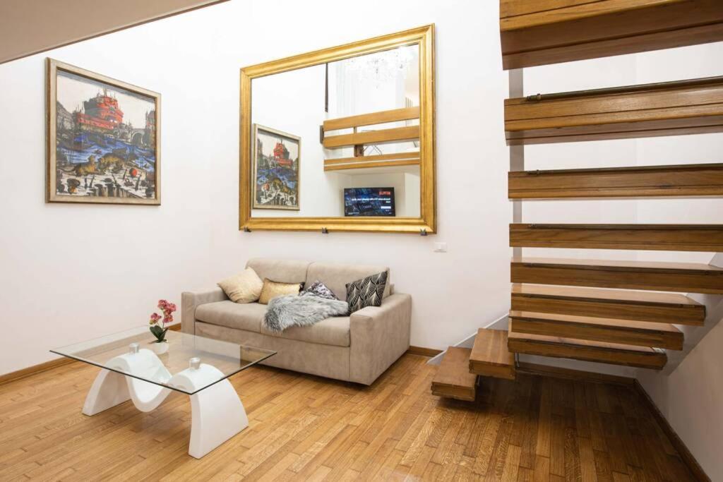 a living room with a couch and a glass table at Unforgettable Split Level Jacuzzi Suite Navona - Top Collection in Rome