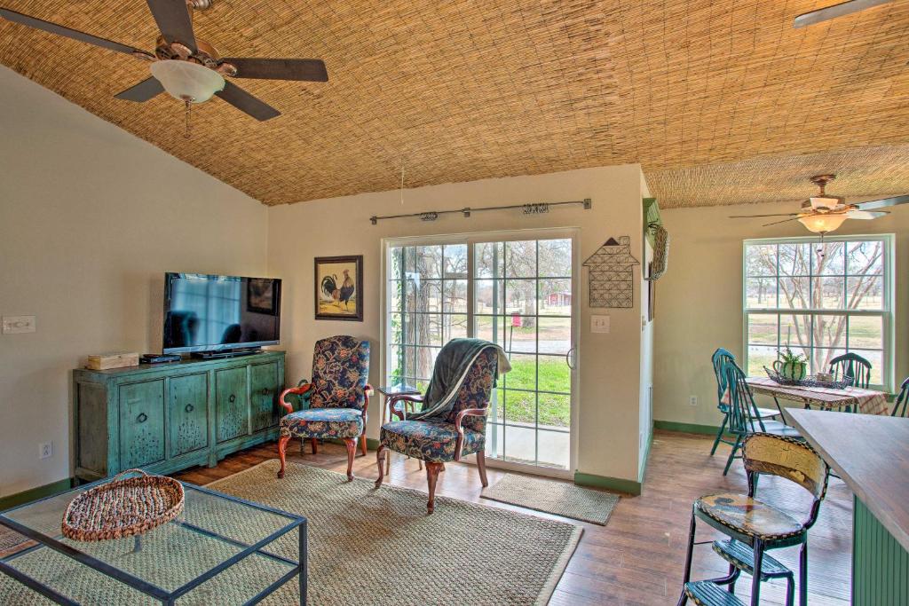 a living room with chairs and a flat screen tv at Quaint Countryside Casita 45 Mi to Ft Worth in Buckner