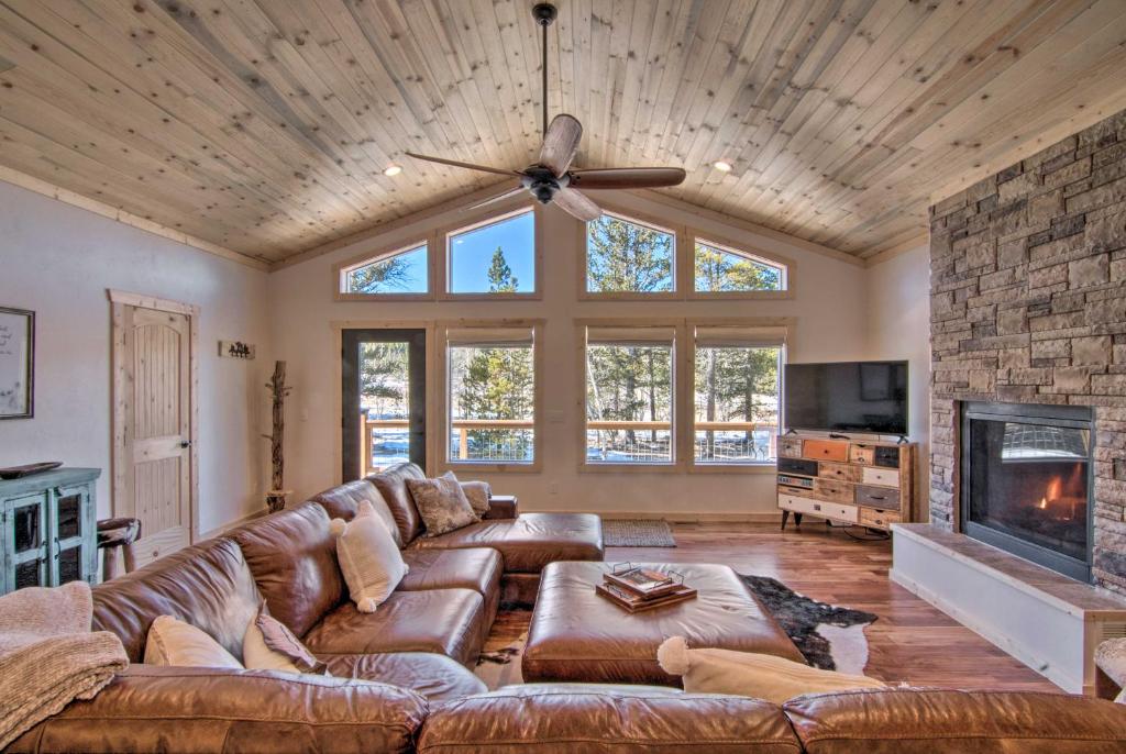 a living room with a couch and a fireplace at Quiet Mtn Cabin with Deck Less Than 5 Mi to Fairplay Beach! in Fairplay