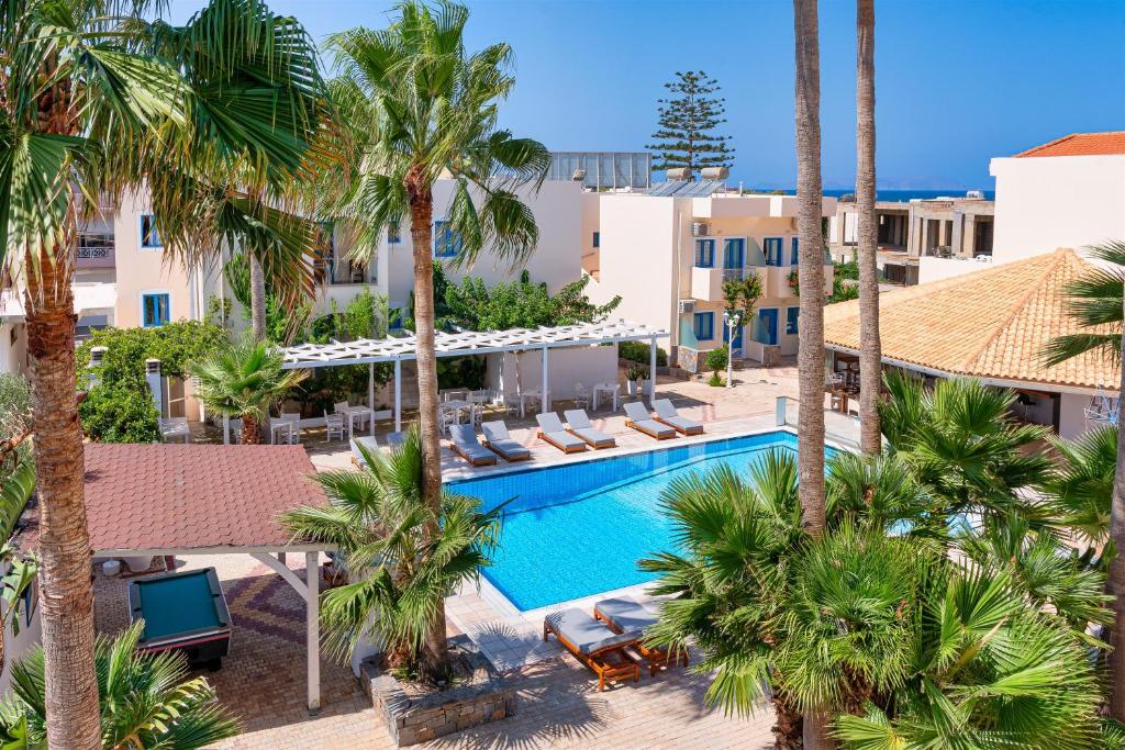 an aerial view of the resort with palm trees and a swimming pool at Nana Angela Apartments in Hersonissos