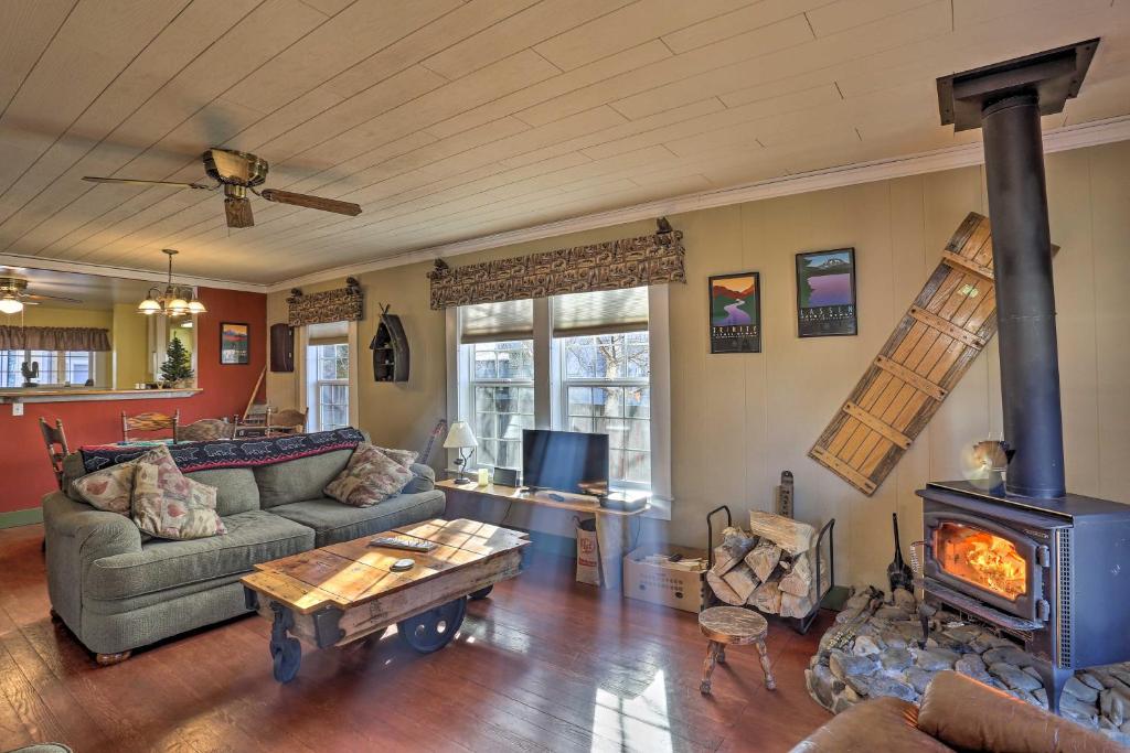 a living room with a couch and a fireplace at Downtown Cabin Less Than 10 Miles to Mt Shasta Ski Park! in McCloud