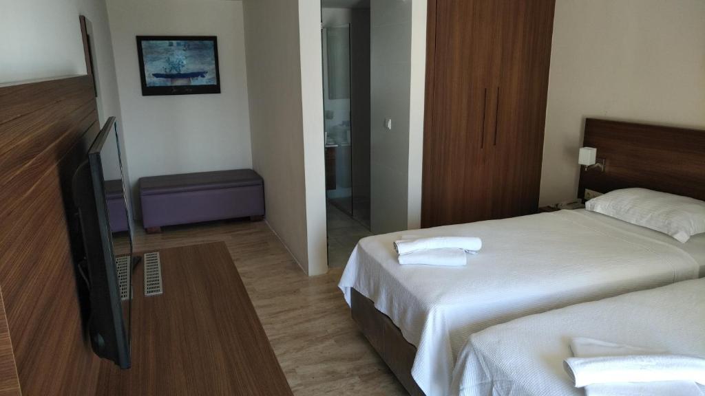 Postel nebo postele na pokoji v ubytování Neopol Hotel