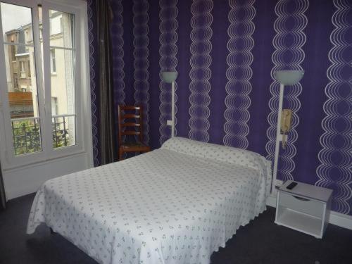 a bedroom with a white bed and a window at Ardenn&#39;Hotel in Reims