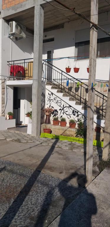 a building with a staircase with potted plants on it at Petkovic Apartmani 3 in Tivat