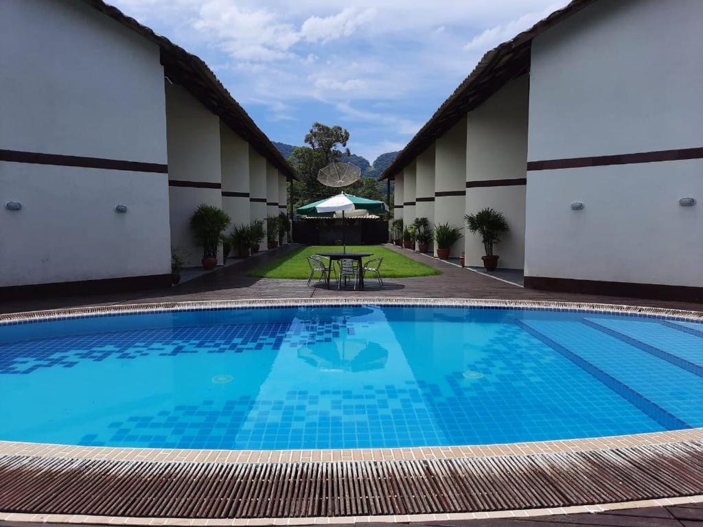 a pool in the courtyard of a hotel at Residencial Villafranca in Boicucanga