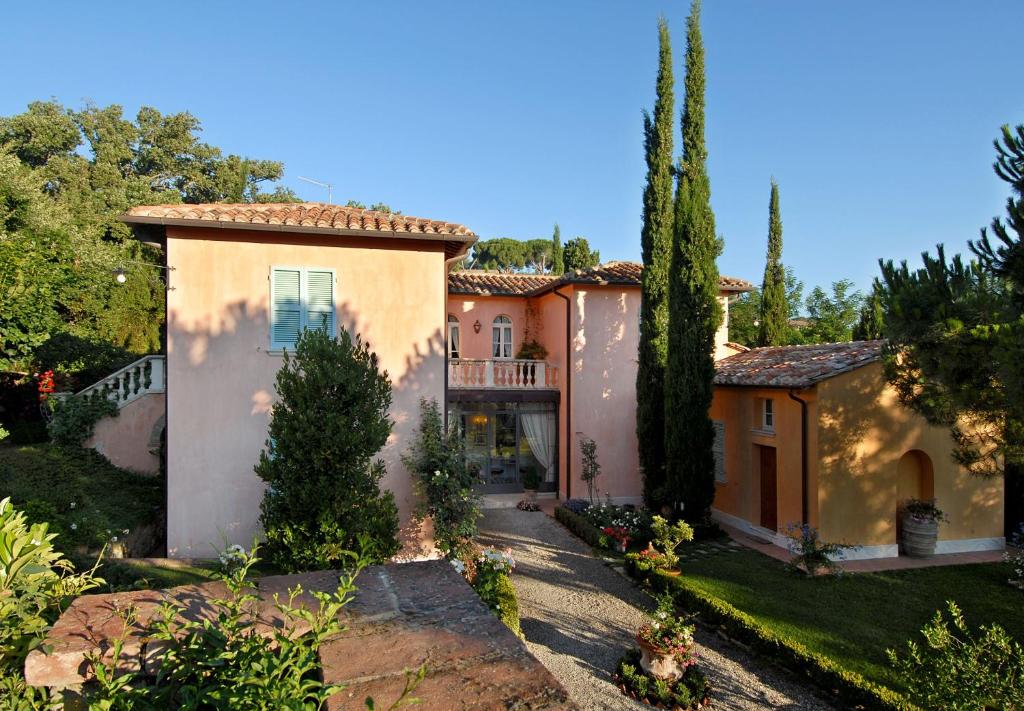 une grande maison avec des arbres et une allée. dans l'établissement Il Rondò Boutique Hotel, à Montepulciano