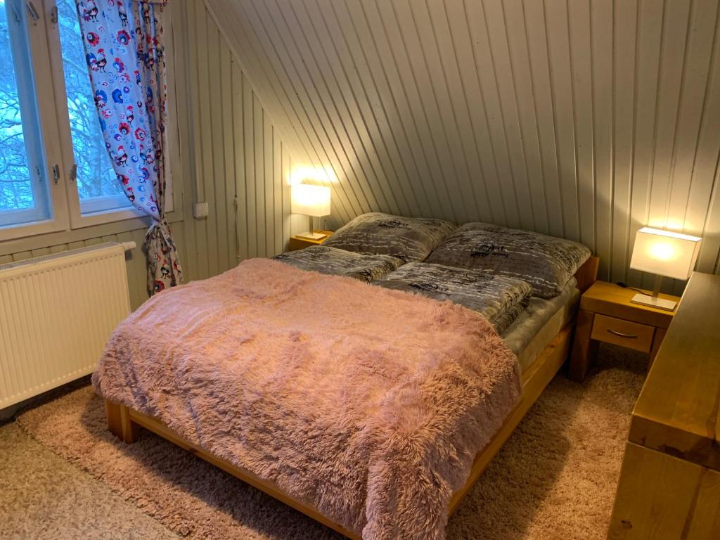 Postel nebo postele na pokoji v ubytování Sosnowy Zakatek