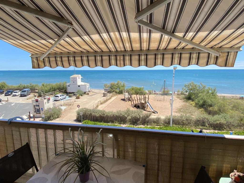 - une vue sur l'océan depuis la terrasse dotée d'une table dans l'établissement Studio climatise 2 couchages, Wifi, VUE MER directement à PORTIRAGNES PLAGE LXBFM10, à Portiragnes